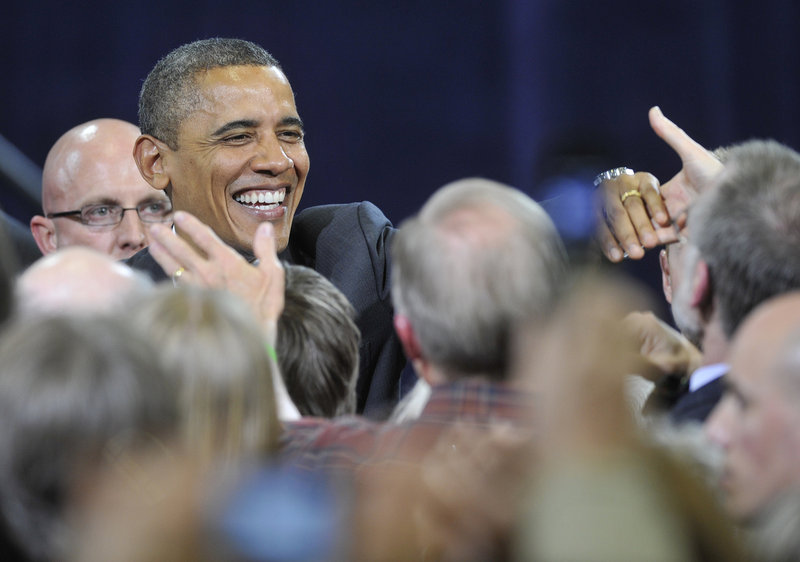 President Barack Obama greets well-wishers after his speech at Southern Maine Community College in South Portland on Friday. His half-hour address sought to rally his base while denouncing Republican policies.