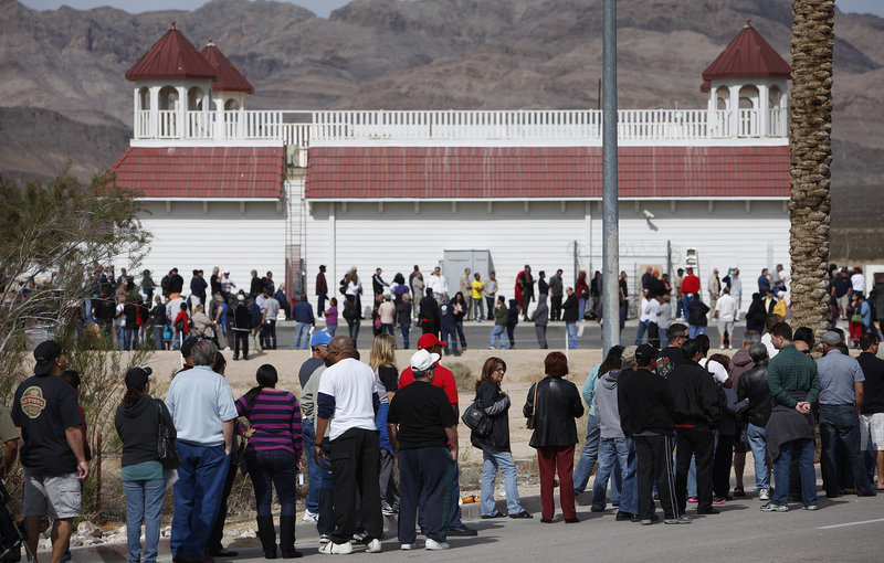People wait in line to buy tickets for the Mega Millions lottery jackpot at the Primm Valley Casino Resorts Lotto Store in California near Primm, Nev., Thursday.