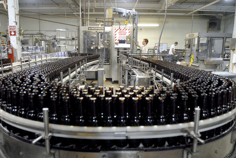 Empty bottles fill a conveyor belt at the Shipyard Brewing Co. in Portland. From 1996 to 2011, the city and the Portland Water District failed to bill the brewery for most of its sewer services, an error that cost the city as much as $1.5 million in lost revenue.