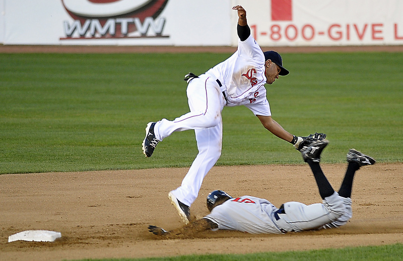 Sea Dogs second baseman Ryan Dent seems to tag Rock Cats Pedro Florimon as he slides into second but Florimon was called safe as Portland hosted New Britain at Hadlock Field in Portland tonight. The Rock Cats won 6-3.