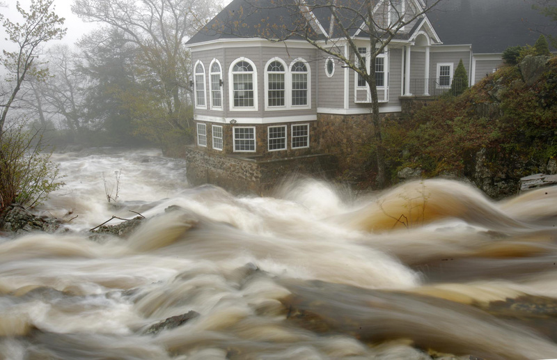 The Ogunquit River, swollen from Monday’s rain, flows past a home in Ogunquit. Parts of southern Maine got more than 4 inches of rain.