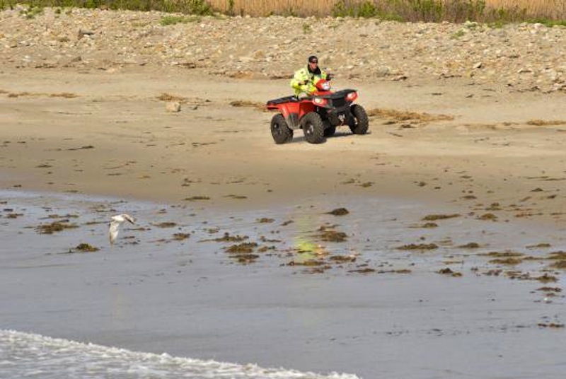 A police officer rides on the closed Rockport beach as part of the search for missing 2-year-old Caleigh Anne Harrison.