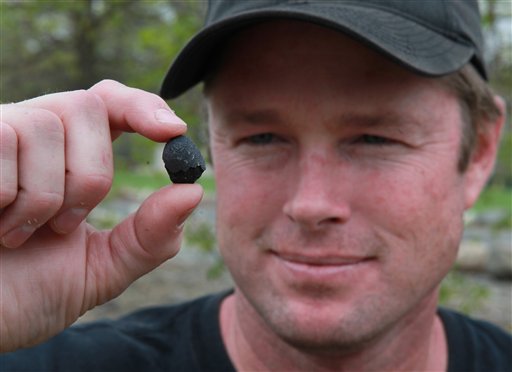 Robert Ward displays one of two pieces of a meteorite he found at a park in Lotus, Calif., on Wednesday. Ward has been hunting and collecting meteorites for more than 20 years.