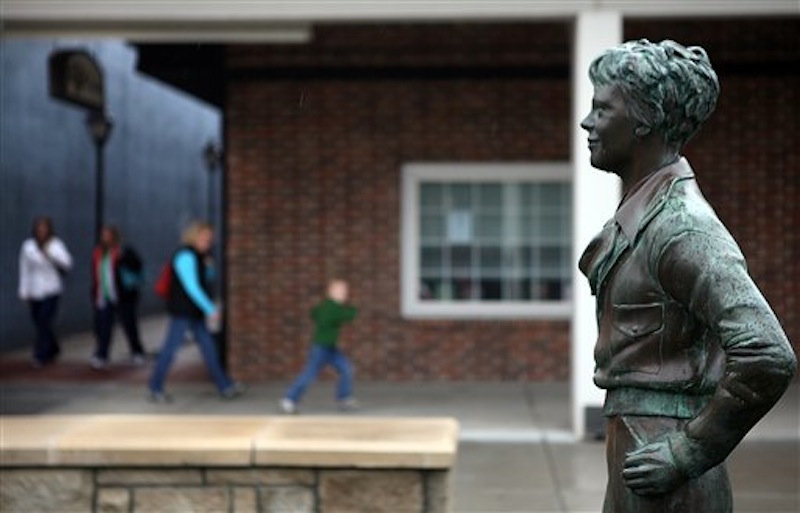 A statue of the famous aviatrix Amelia Earhart greets passersby at the pedestrian mall in downtown Atchison, Kan. on Wednesday, March 21, 2012. Nearly 75 years after her disappearance, the competition to find her remains hot. (AP Photo/The St. Joseph News-Press, Eric Keith )