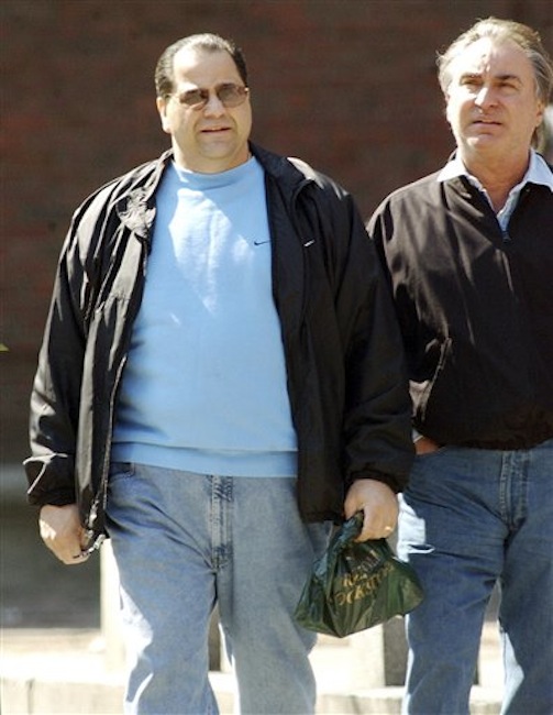 This March 25, 2002 photo shows Carmen Anthony DiNunzio, left, walking with Anthony Gambale, right, on Hanover Street in Boston's North End. A spokesman for the Rhode Island U.S. Attorney's Office said Anthony DiNunzio was taken into FBI custody and is scheduled to be in federal court in Providence, R.I., Wednesday afternoon April 25, 2012. (AP Photo/Boston Herald, Kevin Wisniewski)
