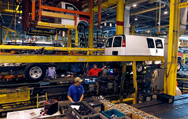 In this Nov. 3, 2011, file photo, General Motors employees work on a van assembly line at GM's plant in Wentzville, Mo. The U.S. auto industry, already stretched to meet growing car and truck sales, faces parts shortages that could limit the number of new vehicles in showrooms later this year and crimp a historic turnaround. The most immediate problem, the shortage of a crucial plastic resin, could surface in few weeks. And later in the year, automakers could face an even bigger crisis, running short of parts simply because there aren't enough factories and people left to make them. (AP Photo/Jeff Roberson, File)