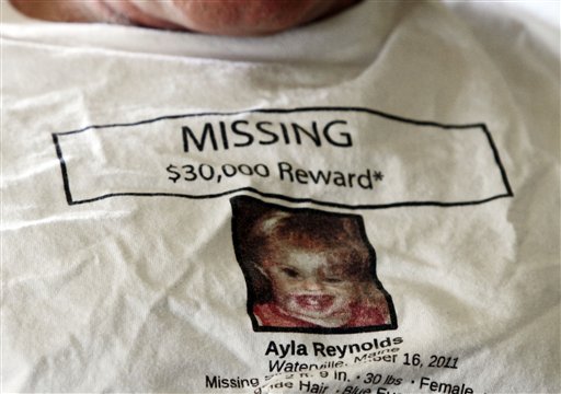 In this March 27, 2012 photo, Jeff Hanson wears a shirt for his missing step-granddaughter at his home in Portland, Maine. Hanson decided he needed to do something constructive as the investigation drew out, so he created the first of two websites aimed at drawing attention to Ayla Reynolds, the Maine toddler who disappeared on the night of Dec. 16 from her father's home in Waterville. The original website has received more than 1 million clicks, and there are now more than a dozen websites, blogs and Facebook pages dedicated to the case of the blond, blue-eyed youngster, helping to raise awareness along with billboards, posters and other conventional means of spreading the word about missing children. (AP Photo/Pat Wellenbach)