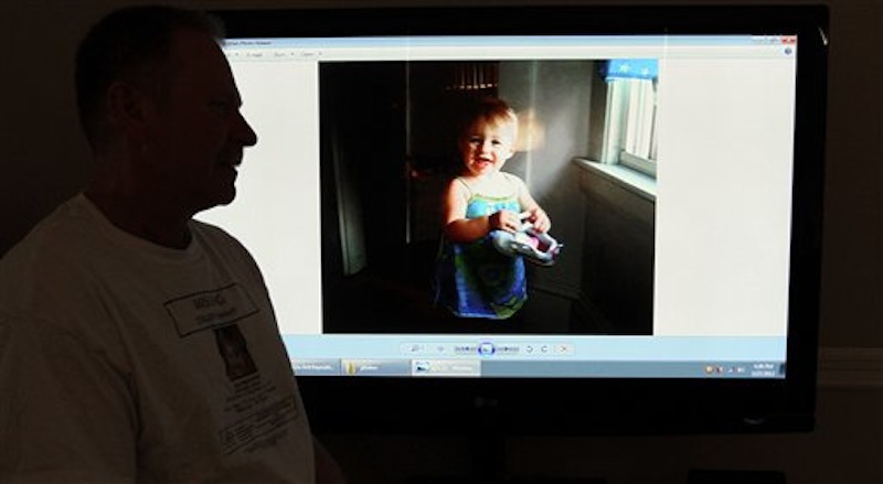 In this March 27, 2012 photo, Jeff Hanson displays a photo on his website about his missing step-granddaughter at his home in Portland, Maine. Hanson decided he needed to do something constructive as the investigation drew out, so he created the first of two websites aimed at drawing attention to Ayla Reynolds, the Maine toddler who disappeared on the night of Dec. 16 from her father's home in Waterville. The original website has received more than 1 million clicks, and there are now more than a dozen websites, blogs and Facebook pages dedicated to the case of the blond, blue-eyed youngster, helping to raise awareness along with billboards, posters and other conventional means of spreading the word about missing children. (AP Photo/Pat Wellenbach)