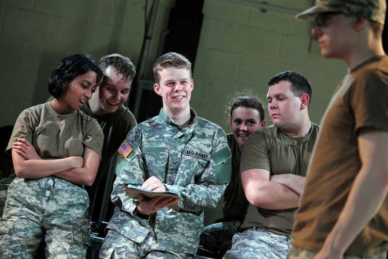 In this photo provided by the National Theatre Wales, on Friday April 20, 2012 Matthew Aubrey,center, plays U.S. Army Pfc. Bradley Manning in the play "The Radicalization of Bradley Manning." To some he's a traitor to his country, to others a free-speech hero. But before he was a public enemy or a cause celebre, U.S. soldier and alleged WikiLeaks source Bradley Manning was a high-school student in west Wales a pivotal period that is the subject of a new British play.