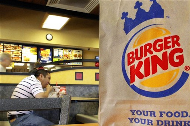 In this Aug. 24, 2010 file photo, patrons enjoy a meal at a Burger King in Springfield, Ill. The movement by U.S. food corporations toward more humane treatment of animals experienced a whopper of a shift Wednesday, April 25, 2012, when Burger King announced that all of its eggs and pork will come from cage-free chickens and pigs by 2017. The decision by the world's second-biggest fast-food restaurant raises the bar for other companies seeking to appeal to the rising consumer demand for more humanely produced fare. (AP Photo/Seth Perlman)