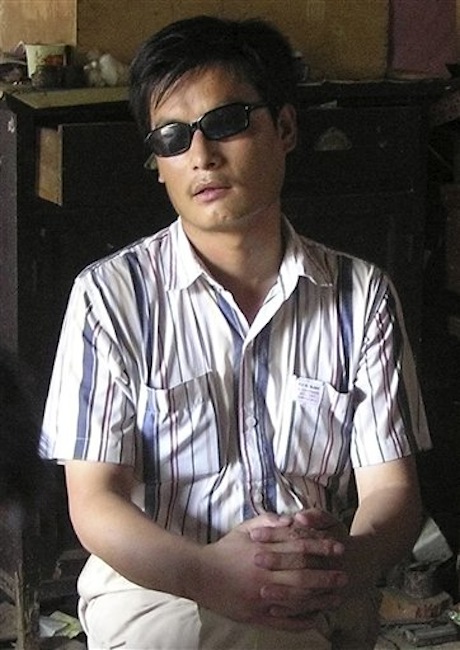 In this undated file photo released by his supporters, blind activist Chen Guangcheng sits in a village in China. Rights campaigners said Friday, April 27, 2012 that Chen, a leading figure in China's rights movement, has escaped the house arrest he lived under for 18 months in Shandong province. (AP Photo/Supporters of Chen Guangcheng, File)