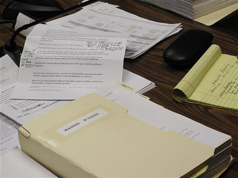 The thick prison file of Charles Manson is shown at a parole hearing at Corcoran State Prison in Corcoran, Calif., Wednesday, April 11, 2012. Mass murderer Charles Manson was denied parole again Wednesday in his 12th and probably final bid for freedom. (AP Photo/Tracie Cone)