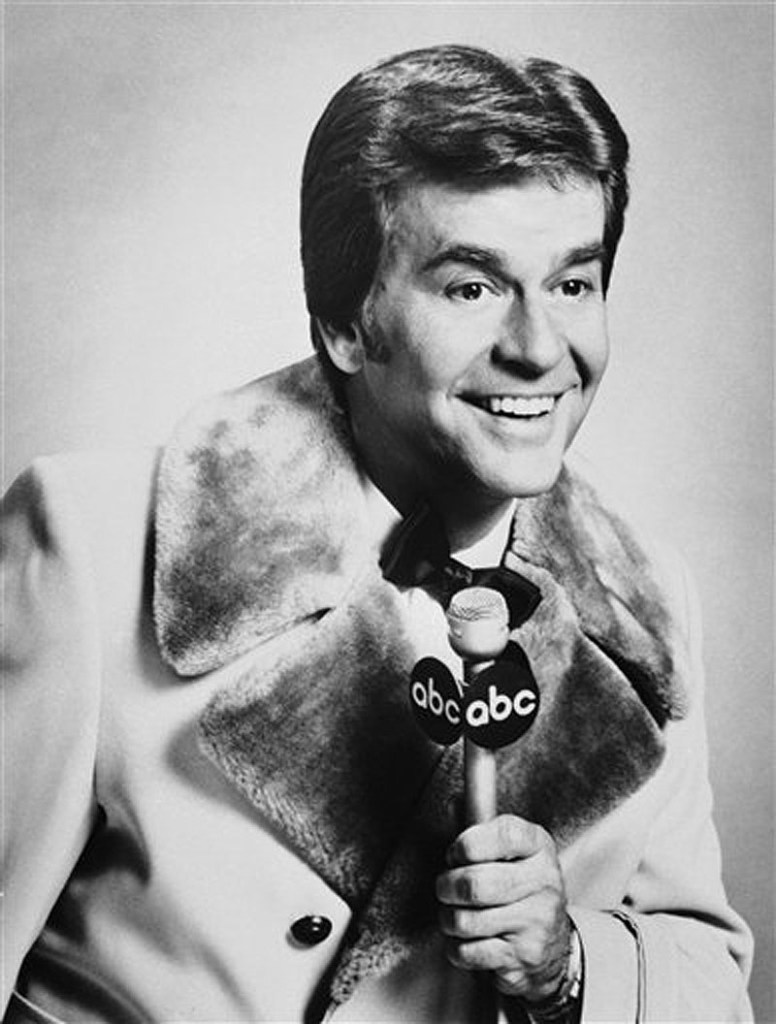 In this Dec. 1980 file photo released by ABC, Dick Clark is shown. Clark, the television host who helped bring rock `n' roll into the mainstream on "American Bandstand," has died. He was 82. (AP Photo/File) Close Up;Communication;Fame;Holding;Looking Away;Microphone;Smil