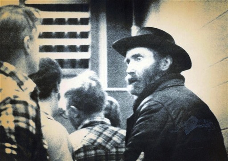 This 1984 image shows "mountain man" Don Nichols, right, being taken into custody near Bozeman, Mont. Nichols, who abducted world-class biathlete Kari Swenson in 1984 to keep as a wife for his son once wrote that blame for the "incident" lies with her and a would-be rescuer he shot and killed. Nichols will likely need to be more contrite in April 2012 when he gets in front of the historically stern Montana Parole Board. (AP Photo/Bozeman Chronicle)