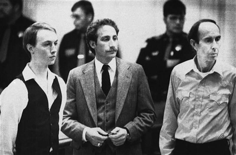 This Dec. 18, 1984 photo shows Don Nichols, right, standing with his son, Dan Nichols, left, as they pled not guilty in court in Virginia City, Mont. Standing with them is attorney, Steve Ungar. Nichols, who abducted world-class biathlete Kari Swenson in 1984 to keep as a wife for his son once wrote that blame for the "incident" lies with her and a would-be rescuer he shot and killed. Nichols will likely need to be more contrite in April 2012 when he gets in front of the historically stern Montana Parole Board. (AP Photo/File)