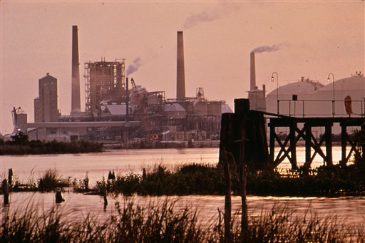 This June 1972 photo released by the U.S. National Archives shows a sunrise over the Olin-Mathieson plant on the Calcasieu River in Calcasieu Parish, La. The photo was taken for the "Documerica" program, 1972-1977, instituted by the then-new Environmental Protection Agency, to document subjects of environmental concern.