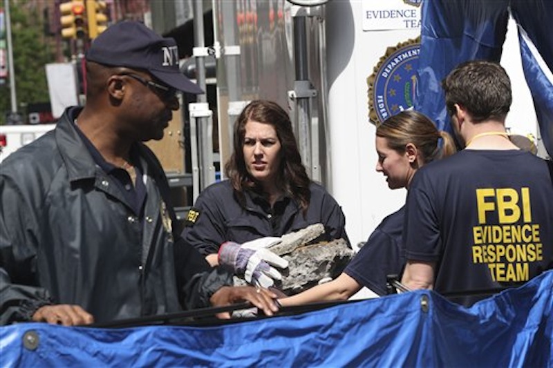Members of the FBI team carry pieces of concrete out of a basement of a building on the corner of Wooster Street and Prince Street in Manhattan during a renewed investigation into the 1979 disappearance of 6-year-old Etan†Patz, on Friday, April 20, 2012 in New York. Patz vanished after leaving his family's home for a short walk to his school bus stop. NYPD spokesman Paul Browne says the building being searched for his remains is about a block from where the family lived. (AP Photo/Mary Altaffer)