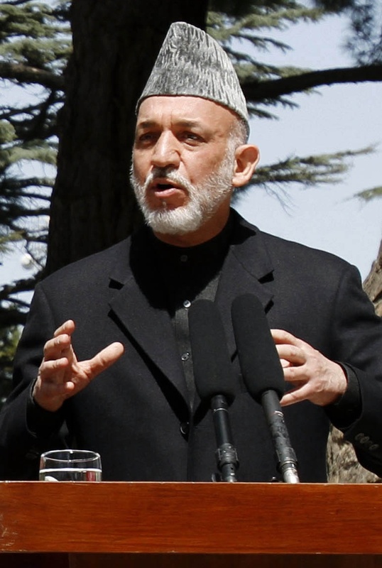 President Hamid Karzai condemned photos of troops with the remains of suicide bombers.