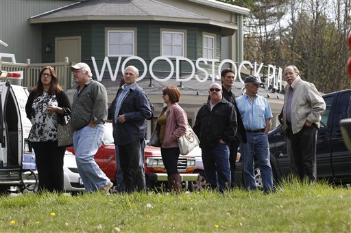 People wait outside the Woodstock Playhouse to board buses to go to a wake for musician Levon Helm at his home today.