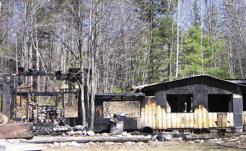 CABIN IN THE WOODS: Sparks from a chimney caused a grass fire Thursday that destroyed a wood cabin home in Wilton built by Larry Bisbee, a man known for hosting free country music concerts on the property.