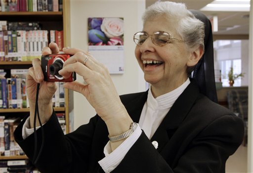 In this April 10, 2012 photo, sister Elaine Lachance takes a photo at the St. Joseph Convent in Biddeford, Maine. Good Shepherd Sisters of Quebec has just five convents in Maine and Massachusetts with fewer than 60 sisters. The youngest is 64, and it's been more than 20 years since a new member has joined. Sister Lachance is using the Internet, social media and even a blog to attract women who feel the calling to serve God. (AP Photo/Pat Wellenbach)