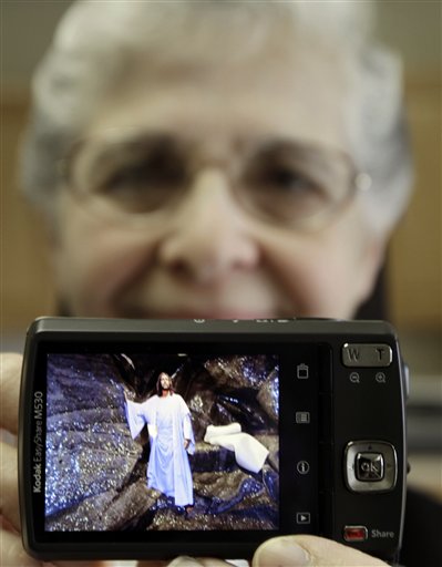 In this April 10, 2012 photo, sister Elaine Lachance holds up her camera displaying a picture she created of a biblical scene, which she intends to use on her blog, at St. Joseph Convent, in Biddeford, Maine. Good Shepherd Sisters of Quebec has just five convents in Maine and Massachusetts with fewer than 60 sisters. The youngest is 64, and it's been more than 20 years since a new member has joined. Sister Lachance is using the Internet, social media and even a blog to attract women who feel the calling to serve God. (AP Photo/Pat Wellenbach)