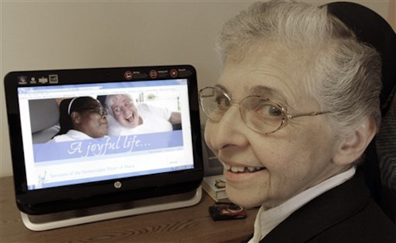 In this April 10, 2012 photo, sister Elaine Lachance works at a computer displaying a photo from the St. Joseph convent on it, in Biddeford, Maine. Good Shepherd Sisters of Quebec has just five convents in Maine and Massachusetts with fewer than 60 sisters. The youngest is 64, and itís been more than 20 years since a new member has joined. Sister Lachance is using the Internet, social media and even a blog to attract women who feel the calling to serve God. (AP Photo/Pat Wellenbach)