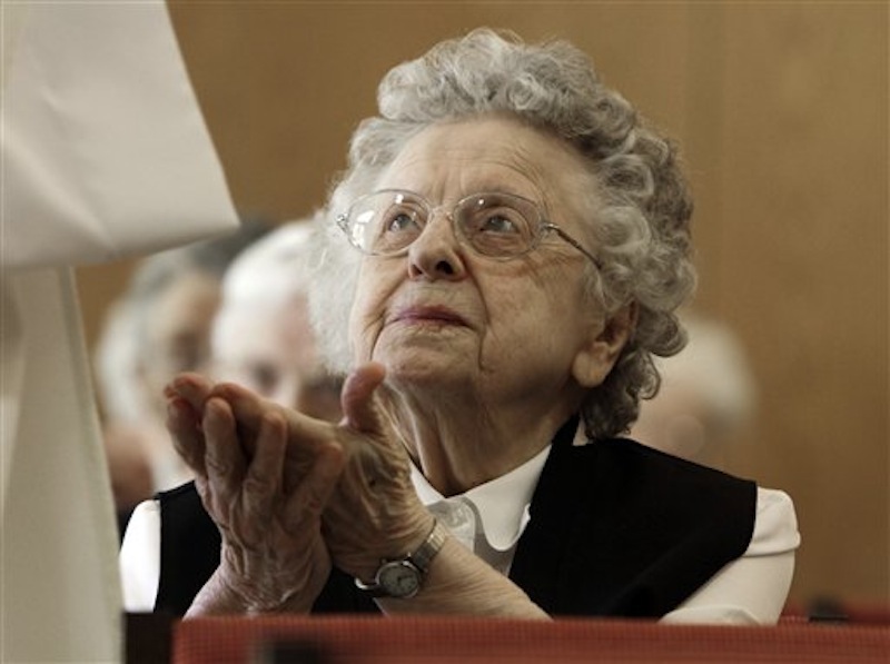 In this April 10, 2012, photo, sister Bertha Duperry, 96, reaches out to take communion during Mass at St. Joseph Convent n Biddeford, Maine. Good Shepherd Sisters of Quebec has just five convents in Maine and Massachusetts with fewer than 60 sisters. The youngest is 64, and itís been more than 20 years since a new member has joined. Sister Elaine Lachance is using the Internet, social media and even a blog to attract women who feel the calling to serve God. (AP Photo/Pat Wellenbach)