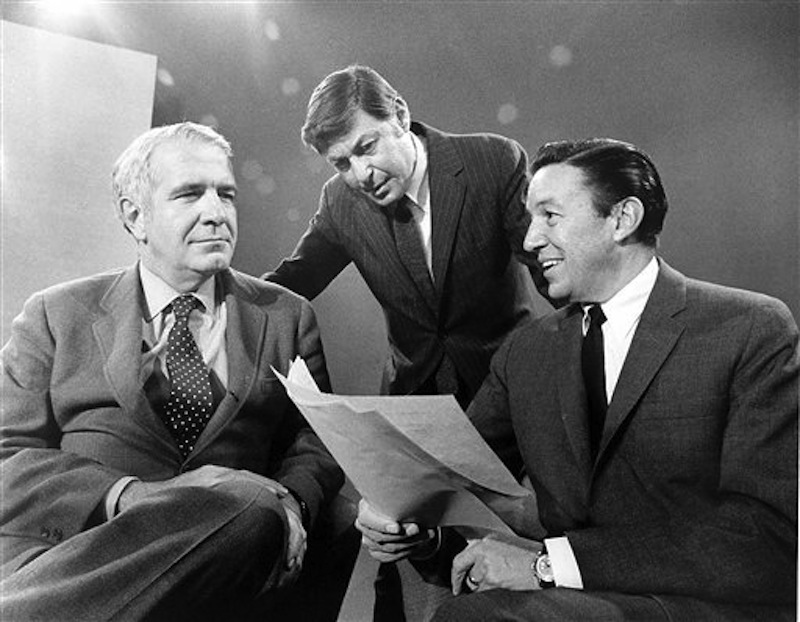 This 1968 photo released by CBS shows "60 Minutes" correspondents Harry Reasoner, left, and Mike Wallace, right, with creator and producer Don Hewitt on the set in New York. Wallace, famed for his tough interviews on "60 Minutes," has died, on Saturday, April 7, 2012. He was 93. (AP Photo/CBS Photo Archive)