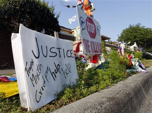 A makeshift memorial for Trayvon Martin is displayed today on the sidewalk outside the complex where Martin was shot dead by neighborhood watch volunteer George Zimmerman in Sanford, Fla.