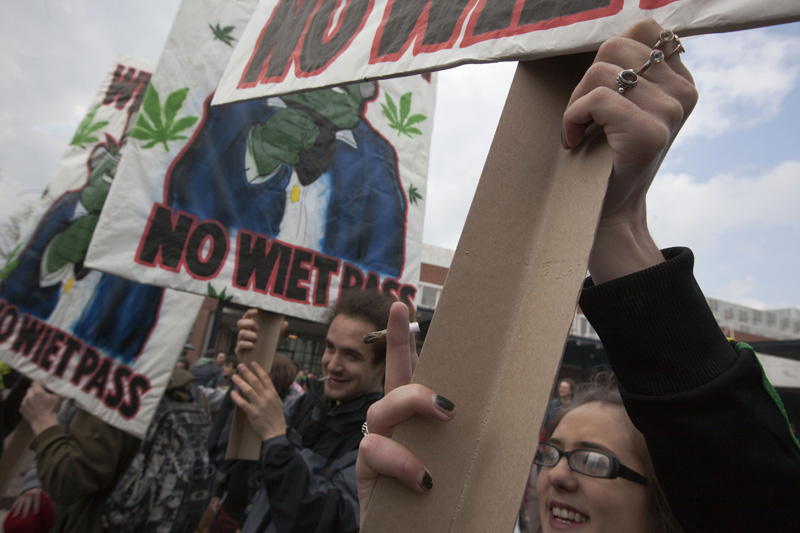 In this recent file photo a woman holds a marijuana joint in Amsterdam during a protest against a government plan to stop foreigners from buying marijuana in the Netherlands.