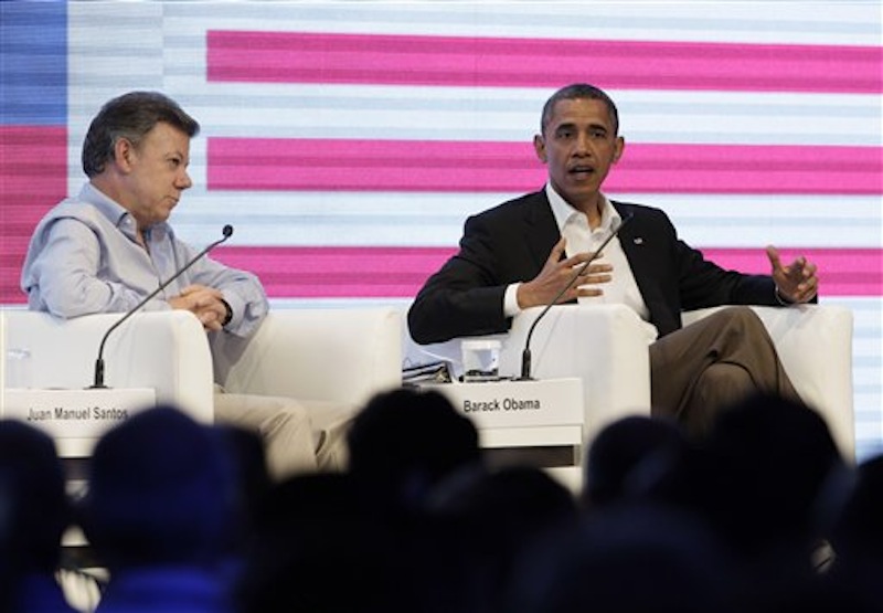 Colombia's President Juan Manuel Santos, left, sits next to President Barack Obama who speaks to an audience gathered at the CEO Summit of the Americas, in Cartagena, Colombia, Saturday April 14, 2012. Regional business leaders are meeting parallel to the sixth Summit of the Americas which brings together presidents and prime ministers from Canada, the Caribbean, Latin America and the U.S. (AP Photo/Carolyn Kaster)