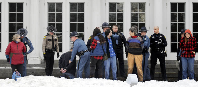 BUSTED: Protesters are arrested on the lawn of the Blaine House during a Nov. 27 rally by Occupy Augusta. Five of the protesters appeared in Kennebec County Superior Court on Wednesday.