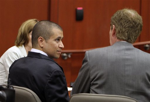 George Zimmerman, left, speaks with his attorney Mark O'Mara as he appears before Circuit Judge Kenneth R. Lester, Jr. last Friday during a bond hearing in Sanford, Fla.