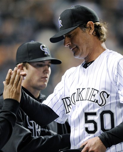 Colorado Rockies starting pitcher Jamie Moyer is congratulated by teammates in the sixth inning of a baseball game against the San Diego Padres on Tuesday in Denver. The Rockies won 5-3.