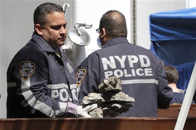 Investigators carry pieces of concrete out of a basement of a building on the corner of Wooster Street and Prince Street in the Manhattan borough of New York on Friday, April 20, 2012 during a renewed investigation into the 1979 disappearance of 6-year-old Etan Patz. Patz vanished after leaving his family's home for a short walk to his school bus stop. NYPD spokesperson Paul Browne says the building being searched for his remains is about a block from where the family lived. (AP Photo/Mary Altaffer)