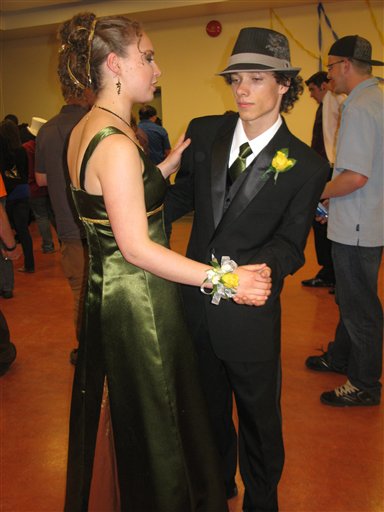 This May 2010 photo released by Karen Schwartz shows Arielle Roberts, left, and Jordan Tomlinson at the prom for Stanley Humphries Secondary School in Castlegar, British Columbia, Canada. Many prom couples want the boy's tie to perfectly match the girl's dres, and Jordan's mother made his green tie from fabric leftover from Arielle's dress. (AP Photo/Karen Schwartz)