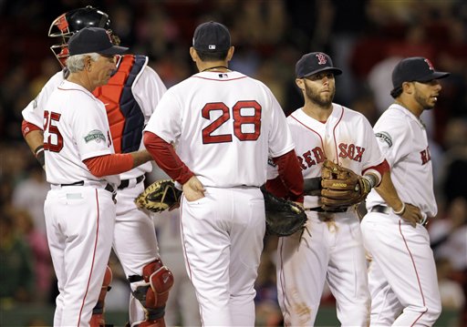 Boston Red Sox manager Bobby Valentine, left, talks on the mound with first baseman Adrian Gonzalez, 28, second baseman Dustin Pedroia and shortstop Mike Aviles, far right, during a pitching change in the eighth inning at Fenway Park in Boston on Tuesday.