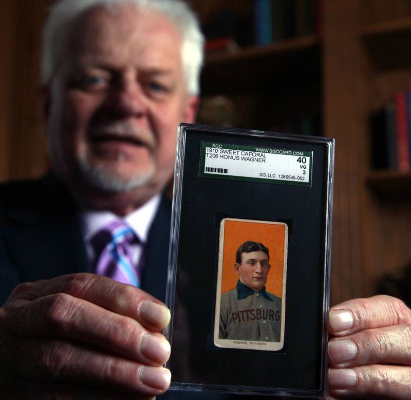 Bill Goodwin holds a 1909 Honus Wagner baseball card last month in Sunset Hills, Mo. Goodwin facilitated an online auction for the card, one of the most sought-after sports collectibles in the world.