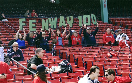 Fans hold up letters honoring the 100th anniversary of Fenway Park prior to the home opener today of the Boston Red Sox against the Tampa Bay Rays.