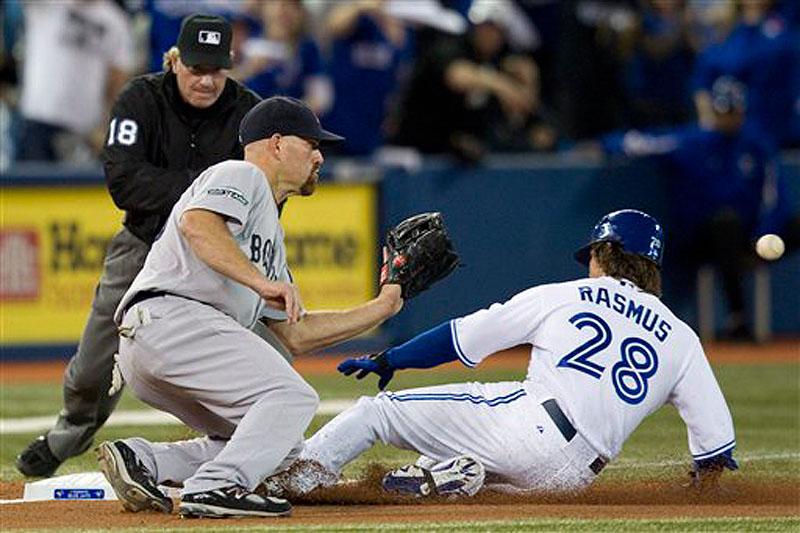 Toronto Blue Jays' Colby Rasmus, right, steals third base against Boston Red Sox's Kevin Youkilis during the third inning of a baseball game in Toronto on Monday, April 9, 2012. The Red Sox lost 3-1, dropping to 1-5 on the season. (AP Photo/The Canadian Press, Frank Gunn) color;full length;Toronto;Toronto Blue Jays;colour;sports;play;p