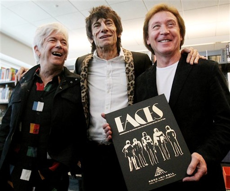 Members of the Faces rock group Ian McLagan, left, Ronnie Wood, center, and Kenney Jones pose with their book "Faces (1969-1975)" after news conference Friday, April 13, 2012 in Cleveland. (AP Photo/The Plain Dealer, John Kuntz) ROCK GROUP FACES;IAN MCLAGAN;RON WOOD AND KENNEY JONES AT THE