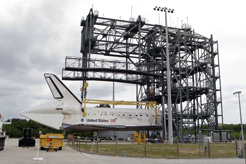 Space shuttle Discovery waits at the Mate-Demate structure to be to be mounted atop a 747 carrier jet, not pictured, at the Kennedy Space Center, Saturday, April 14, 2012, in Cape Canaveral, Fla. Discovery will be transported to the Smithsonian National Air and Space Museum in Washington on Tuesday, April 17.