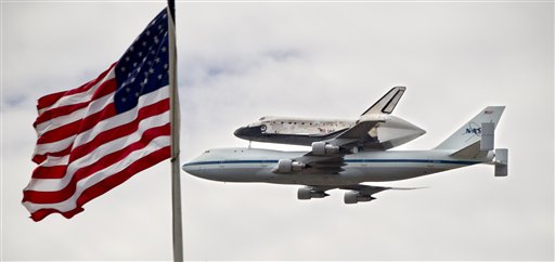 The space shuttle Discovery soars past Capitol Hill in Washington today, atop a special NASA Boeing 747 jet.