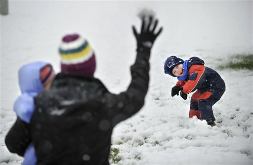 Evan Dreibelbis, 3, tries to avoid a snowball during a snowball fight in fresh snow in their front yard with his mother Dana Dreibelbis and sister Elle today in Pine Grove Mills, Pa.