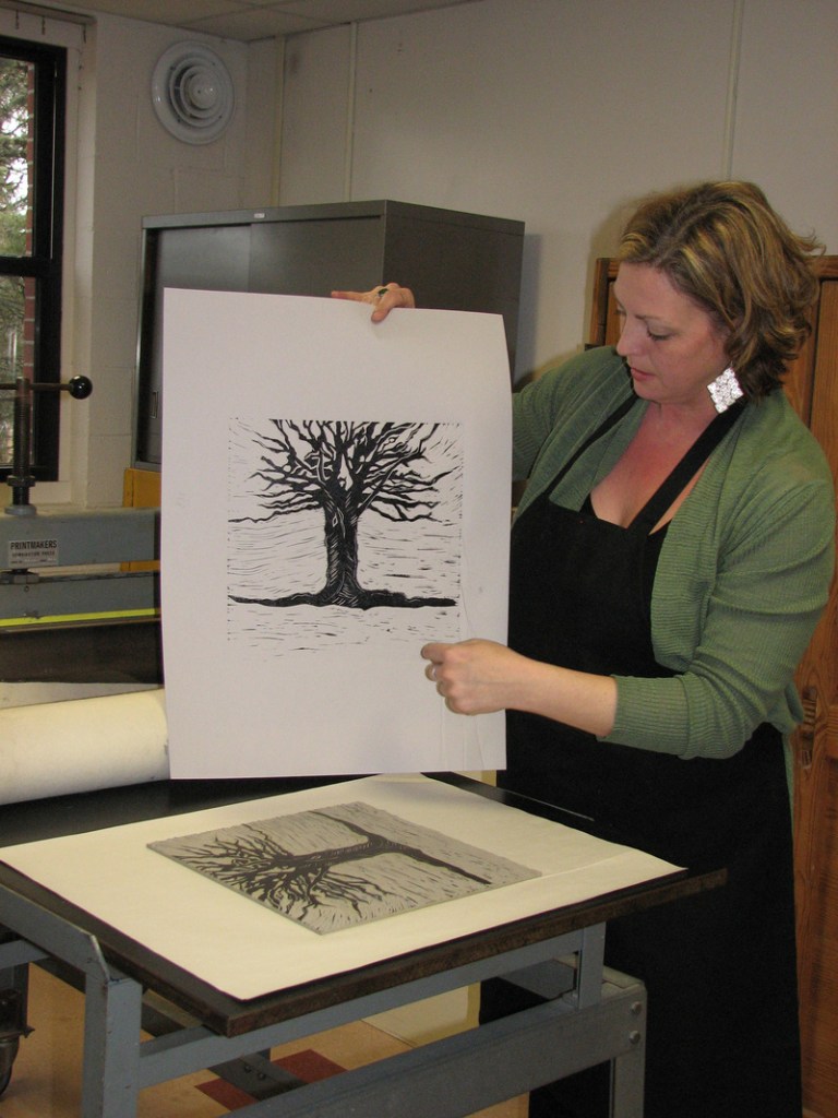 Hosanna Jensen, a UMaine-Machias student and member of the design team, studies an image being considered for the cover of “Julia and the Illuminated Baron.”