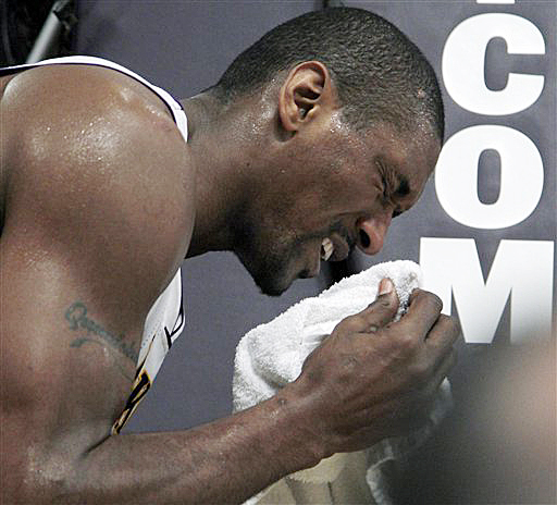 Los Angeles Lakers forward Metta World Peace puts a towel to his nose after taking a hit from Oklahoma City Thunder's Serge Ibaka in the first half of a game in Los Angeles on Sunday.
