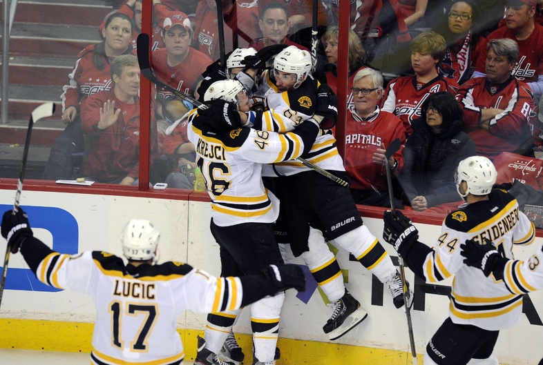 Tyler Seguin scores the winner for Boston in OT Sunday, then gets mobbed by teammates David Krejci, left, and Brad Marchand in Game 6 at Washington. The Bruins fought off elimination and are home for Game 7 Wednesday night.