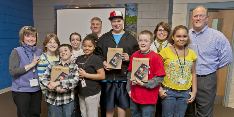 The Boys & Girls Clubs of Southern Maine’s South Portland Clubhouse has received three new Kindle Fire e-readers from Time Warner Cable for participating in the company’s Connect a Million Minds program. From left, Jen Pierce, unit director of the South Portland Clubhouse; Virginia Saunders, Max Johnson, Kaitlyn DiRenzo, Aliyah Palmer, Time Warner Cable communications manager Andrew Russell, Jacob Noon, Will Kirk, Boys & Girls Clubs of Southern Maine CEO Karen MacDonald, Suzy Valesquez, Time Warner Cable area vice president Paul S. Schonewolf.