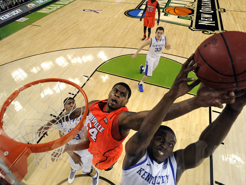 Darius Miller of Kentucky gets positioned to pull down a rebound in front of Chane Behanan of Louisville during Kentucky’s 69-61 victory Saturday at the Final Four.